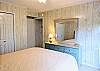 Bright sun-filled area of D4 Briar Court with large closets and an entry to the primary bedroom suite.