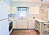 Kitchen view showing the integrated breakfast bar area, perfect for casual vacation dining at D4 Briar Court.