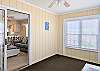 Sun-filled sunroom space in D4 Briar Court with large window view, coastal-inspired decor.