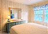 Comfortable sitting room at D4 Briar Court with a large mirror teal storage console.