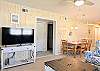 Comfortable sitting room in D4 Briar Court with a large flat-screen TV and white entertainment console.