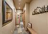 Entry hallway located on the first floor with bench and coat hooks.