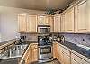 Granite counters, stainless steel appliances, and double sinks.