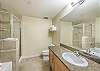 Granite counters, large vanity area, separate glass shower, and large bath tub.