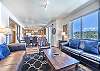 Living area, dining area, and kitchen all flow together nicely with the open floor plan.