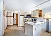 Kitchen-
Large granite counter top space, full size appliances, and track lighting above.