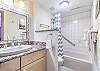Nicely upgraded, bright bathroom with granite counters.