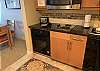 Small under-counter oven, 2 counter top electric burners,  under-counter over, and microwave..