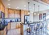 Beautiful cabinetry, lots of counter space, and bar stool seating at the island.