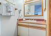 Bathroom-
Vanity lighting, large mirror, and wall mount hair dryer.