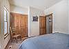 Fourth Bedroom-
Wall mounted flat screen TV, closet space, and king bed.