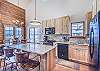 Kitchen-
Granite counters, double sinks, wine chiller, and seating for three at the island.