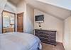 Third Bedroom-
Flat screen TV, dresser for unpacking, and queen bed.