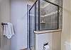 En-Suite Bathroom-
Glass shower stall in the bathroom located off the second bedroom.