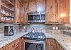 Stainless steel gas range with above range microwave. 