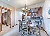 Seating for 7 with 4 chairs around the dining table and 3 bar stools at the kitchen island. 