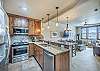 Full size stainless steel appliances and granite counters. 