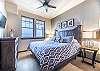 King bed, flat screen TV, and closet space. 

Not shown:  This property uses the Triple Sheet Method where we use two sheets to encase the comforter.  This sheet-made duvet cover gets washed between each and every guest to provide an extra clean sleeping experience.  