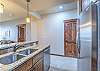 Double sink, ample counter space, and a variety of cooking utensils for creating the perfect vacation meal.