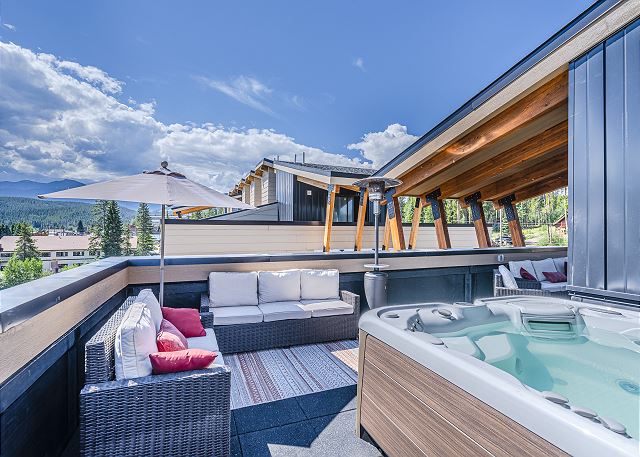 An amazing amenity which includes lounge style seating, patio dining set, private hot tub, and beautiful views.