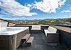Enjoy the amazing views from the rooftop with seating and large hot tub.