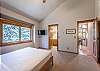 Second Bedroom-
Located on the upper level of the home with a queen bed, flat screen TV, and en-suite bathroom.