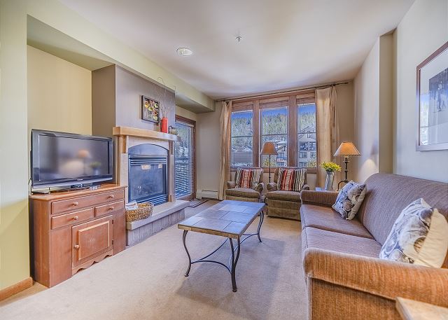 Living Area-
Flat screen TV, fireplace, and access to the private balcony. 