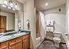 En-Suite Bathroom-
Located off the second bedroom with a full size tub/shower combo and dual sink vanity. 