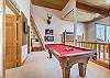 Overlooks the main area of the home and comes complete with a pool table and ping pong table top. 