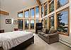 Top floor master bedroom with amazing views through the large windows, king bed, sofa, TV, and en-suite bathroom. 