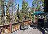 Larger table and seating area located on the deck makes it the perfect spot to enjoy a meal outdoors. 