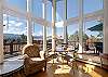 Small dining nook located off the living room perfectly encased in the natural lighting through the large windows. 