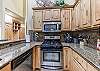 Modern kitchen with high ceilings.  Stainless steel appliances and gas range.