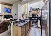 Modern kitchen with stainless steel appliances and gas range.