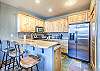 Kitchen with bar/peninsula. Stainless steel appliances. Bar offers additional seating for 3. 