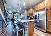 Beautiful kitchen with stainless steel appliances, granite counters, and hardwood flooring.