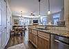 Open kitchen with stainless steel appliances & granite countertops