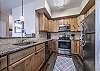 Open kitchen with stainless steel appliances & granite countertops