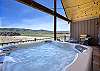 Enjoy a soak in the hot tub while taking in the mountain views.