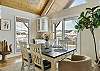 Dining area with seating for 6, deck access, and wine fridge. 