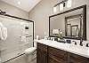 En-Suite bathroom located off the master bedroom offers a dual sink vanity with large walk-in shower. 