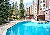 Two hot tubs next to the heated pool.