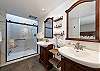 Master bathroom with two separated sinks and shower.