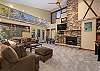 Natural lighting, vaulted ceiling, flat screen TV, gas fireplace, and plenty of seating.