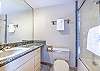 Located off the second bedroom with a full size tub/shower combo and single sink vanity. 