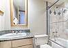 Located off the common areas with full size tub/shower combo, and single sink vanity.