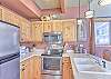 Kitchen-
Full size stainless steel refrigerator, glass top stove, dishwasher, and above range microwave.