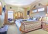 Master Bedroom-
Located on the top floor with king bed, flat screen TV, en-suite bathroom, and french doors that open to an indoor balcony overlooking the living area.