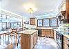 Large windows above the sink provide natural lighting.