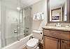 Ensuite bathroom for 2nd bedroom with shower / tub and vanity
